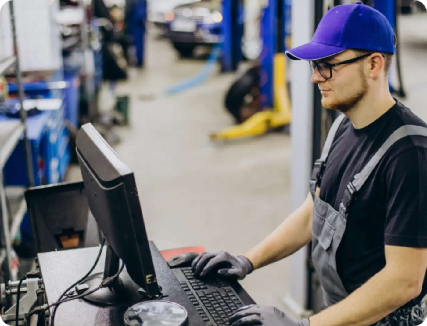 Mechanic working at a terminal in an equipment workshop